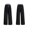 High-waist straight-leg trousers with a button detail on the leg in black or grey.