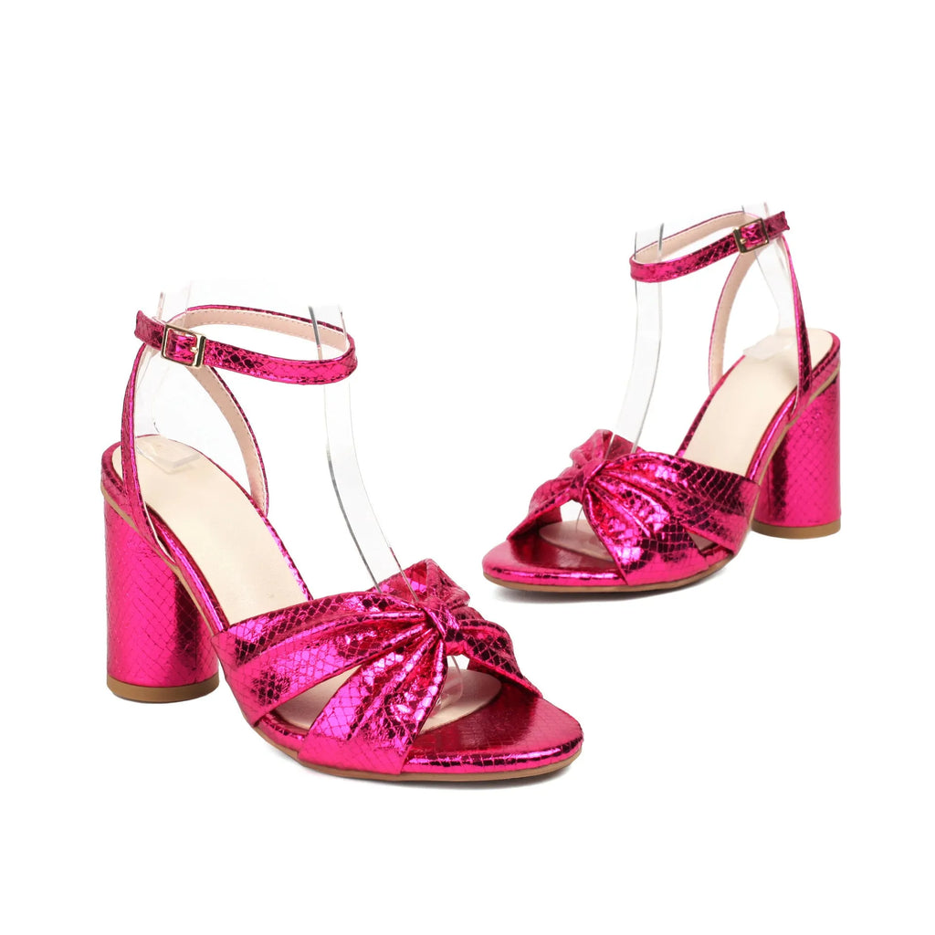 Gold women's high heel peep toe sandals with an ankle buckle on a white background.