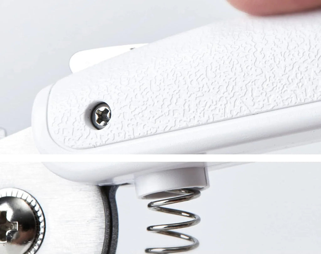 White pet nail clippers with LED light, transparent guard, and nail file on a grey background.