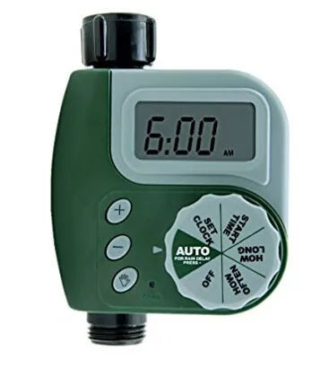 Green digital programmable water timer with display and dial attached to a garden hose faucet.
