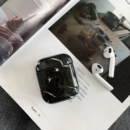 White marble pattern AirPods protective case with hard PC construction showing charging port access