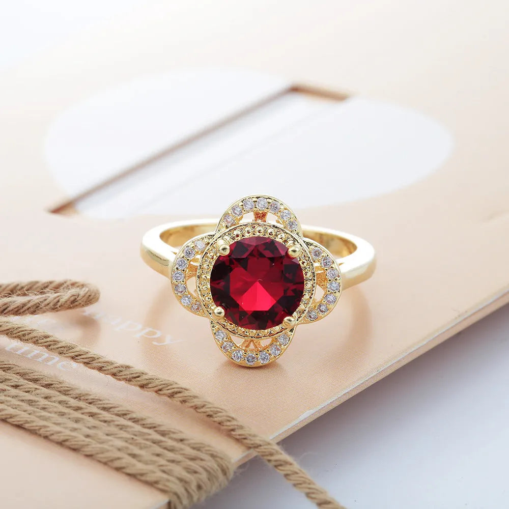 Copper ring with a fruit-shaped zircon stone inlay on a finger.
