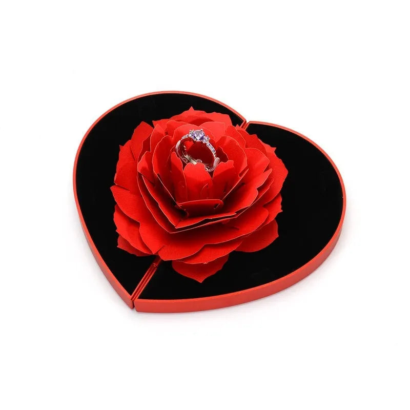 Red 3D heart-shaped rotating ring box with a rose flower decoration, open to show ring placement.