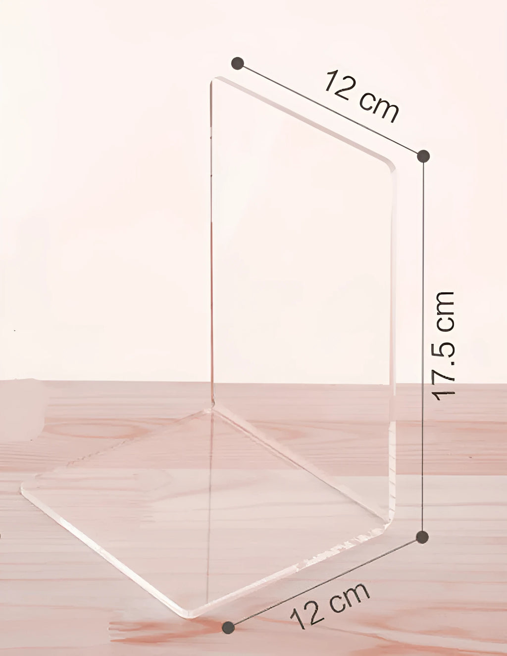 Transparent acrylic bookshelf holding a small stack of books on a wooden desk.
