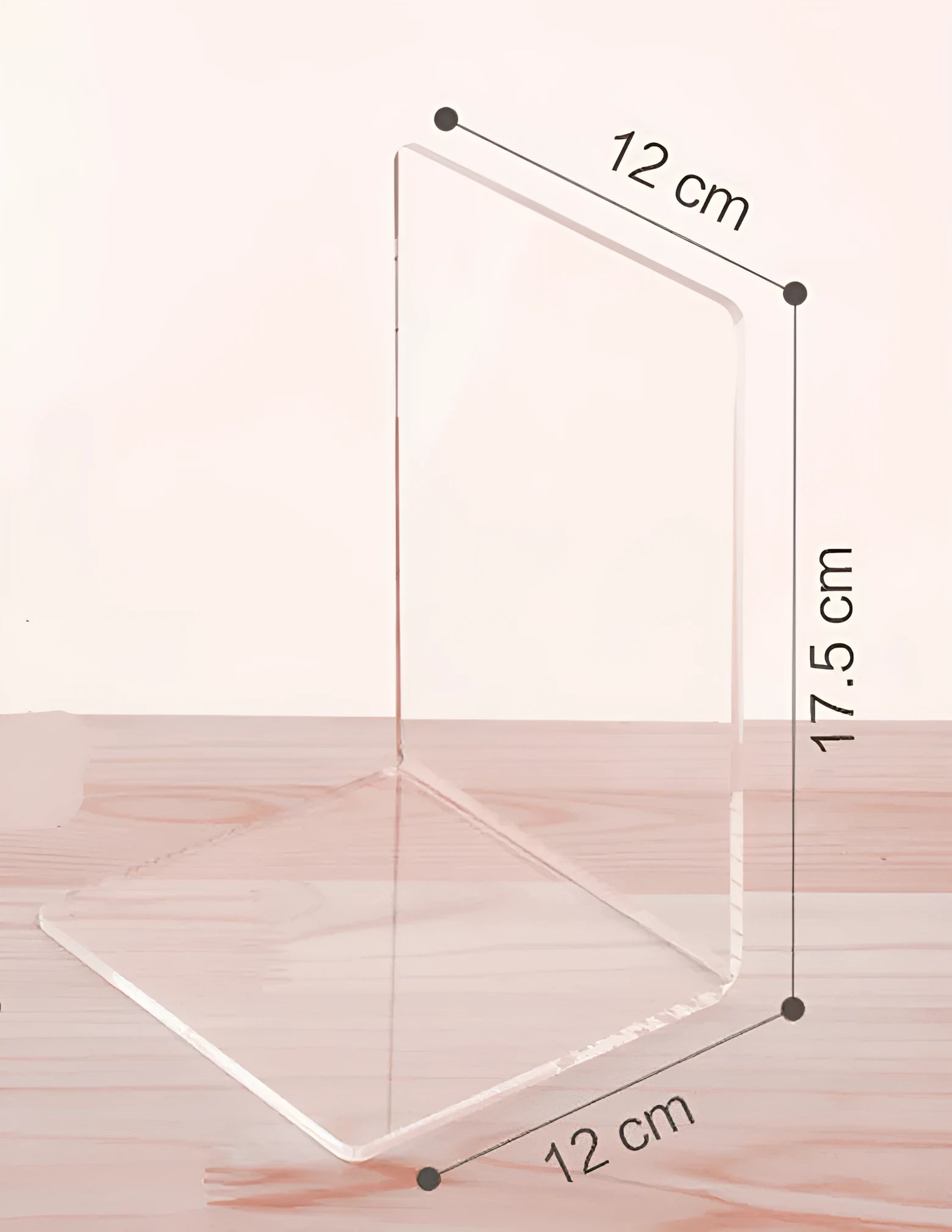 Transparent acrylic bookshelf holding a small stack of books on a wooden desk.