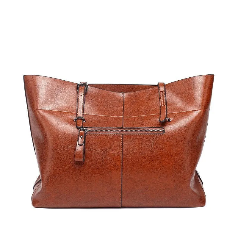 Brown cowhide leather cross body ladies handbag showing two main compartments and internal phone pouch.