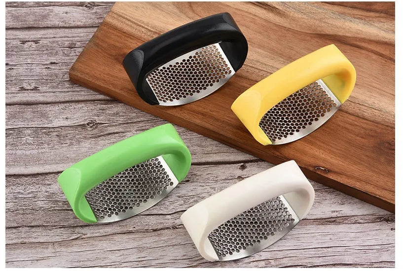 Silver 304 stainless steel garlic press with ergonomic ABS handle on a kitchen counter