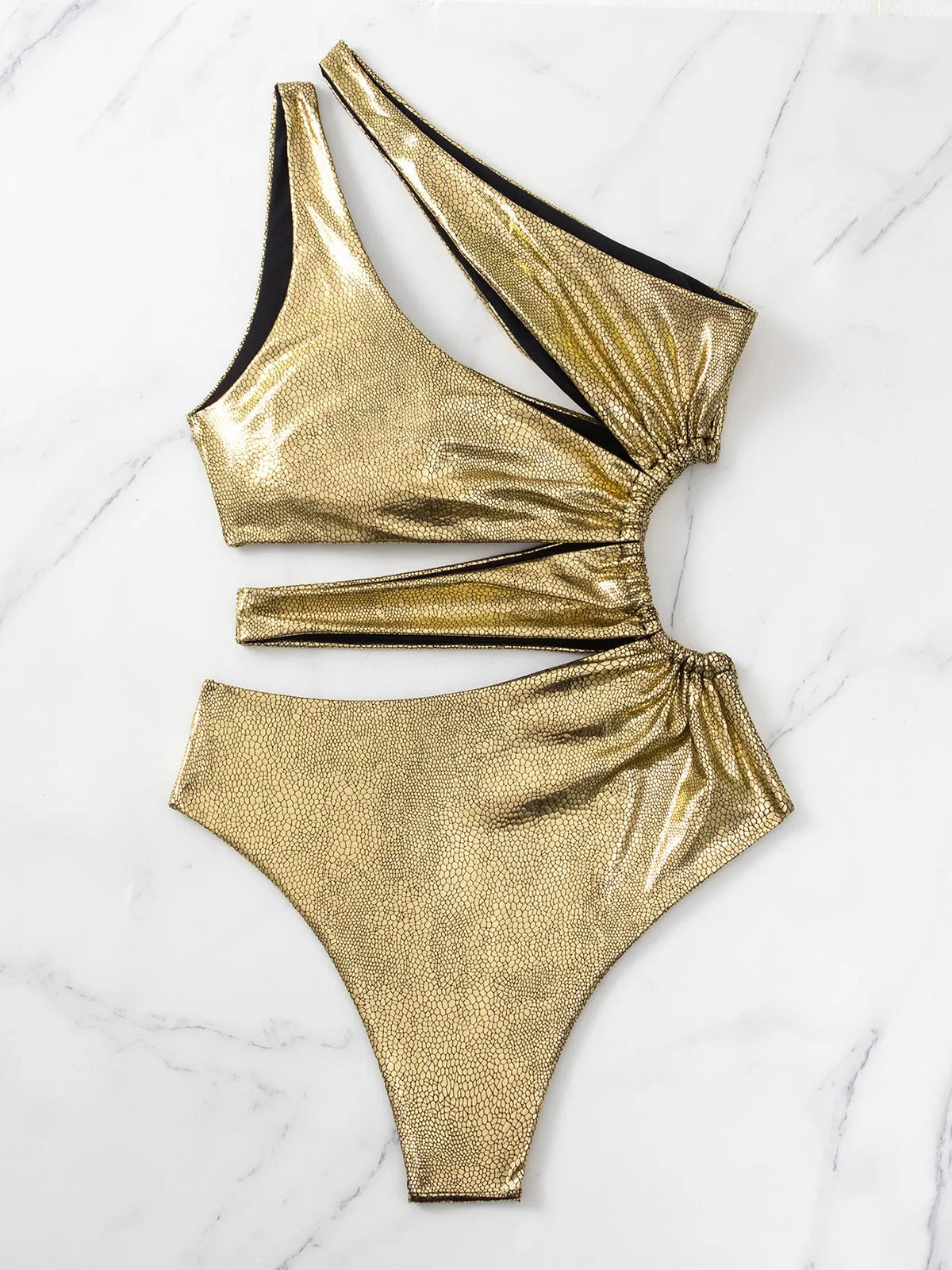 Gold women's one-piece swimsuit with backless design and spandex construction for swimming