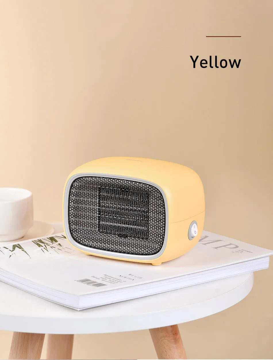 Compact green portable ceramic fan heater on a wooden desk