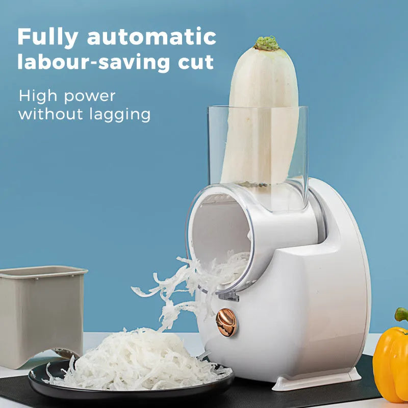 White electric vegetable slicer with rotary grater, feeding port, and three cutting blade pairs on kitchen counter