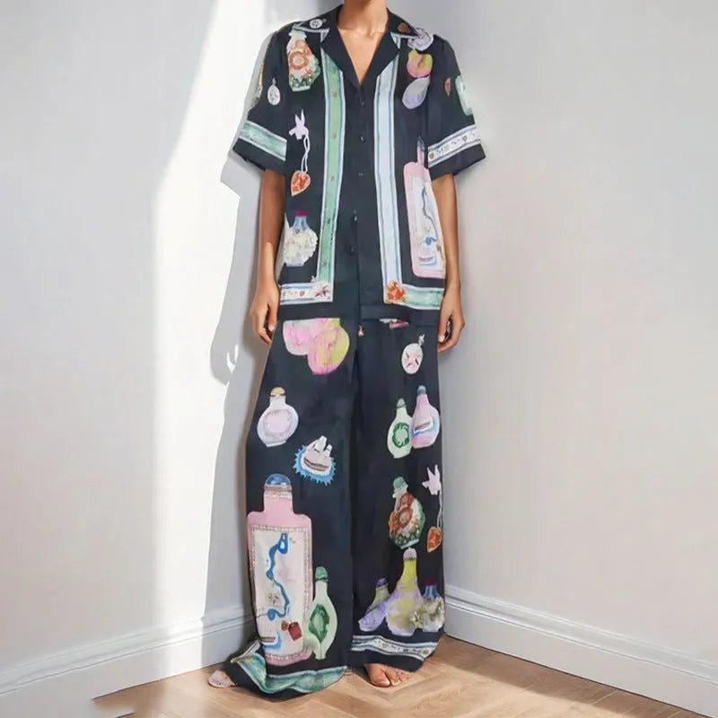 Black women's casual set with cartoon print, featuring a top with regular sleeves and matching trousers.