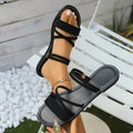 Women's flip-toe buckle sandals with cross straps in black, brown, or green colours