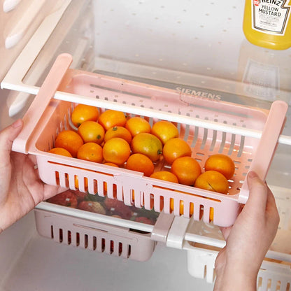Stretchable refrigerator storage basket in white, blue, pink, and apricot colours