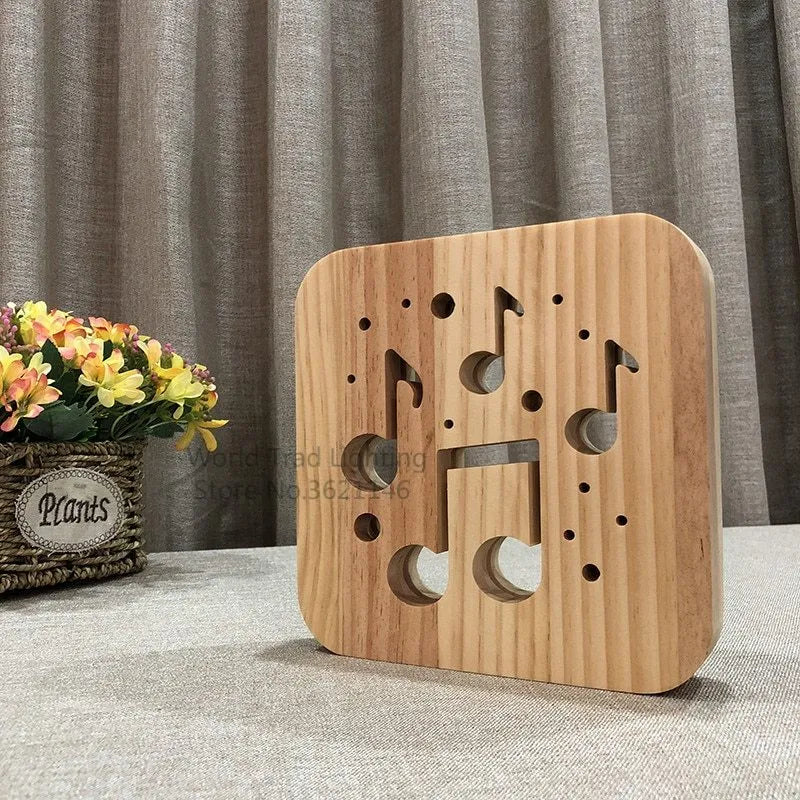 Square pine wood USB LED lamp emitting warm white light on a desk.