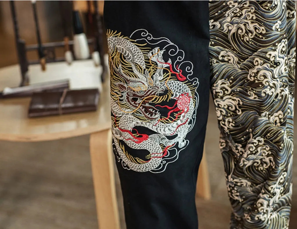 Embroidered silver dragon pattern on beige cotton casual trousers with mid-waist design
