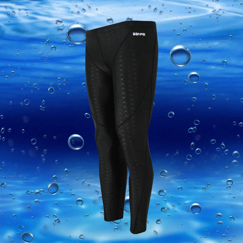 Men's black and grey cropped nylon swimming trunks with mesh lining laid flat.