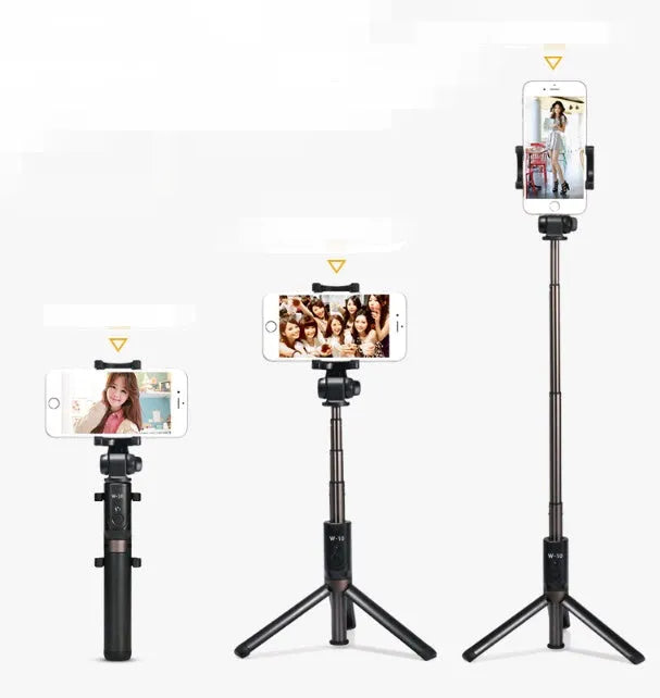 Aluminium telescopic Bluetooth selfie stick with tripod base and remote control next to a smartphone.