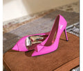 Pink women's patent leather pointed toe stiletto high heels with a buckle on the vamp.
