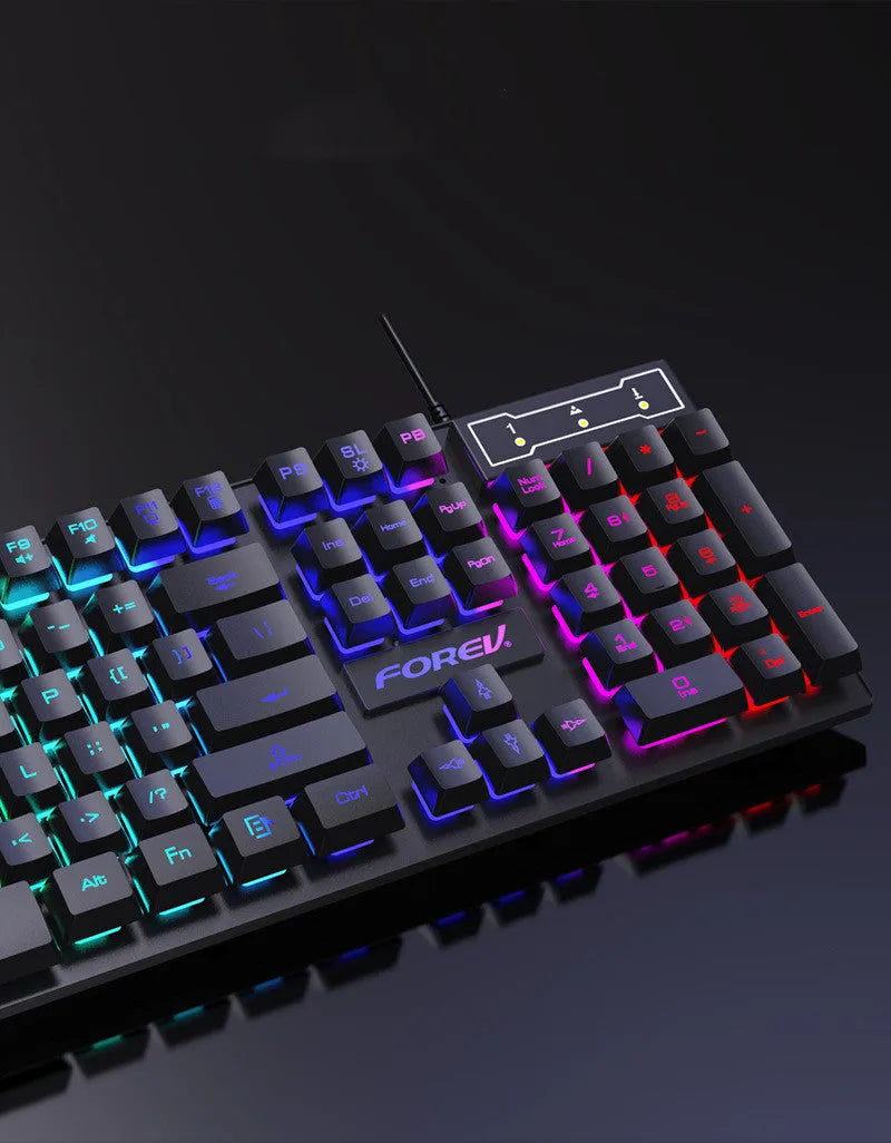 Wired four-piece keyboard mouse headset and mouse pad set with USB cables on a desk