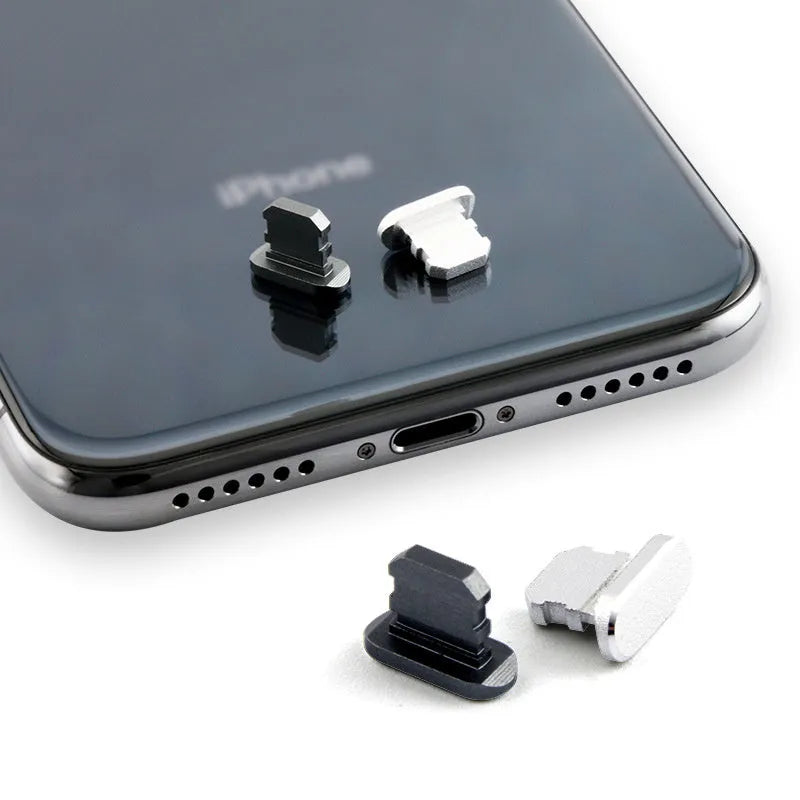 Aluminium alloy iPhone charging port dust plug in silver, shown next to an iPhone.