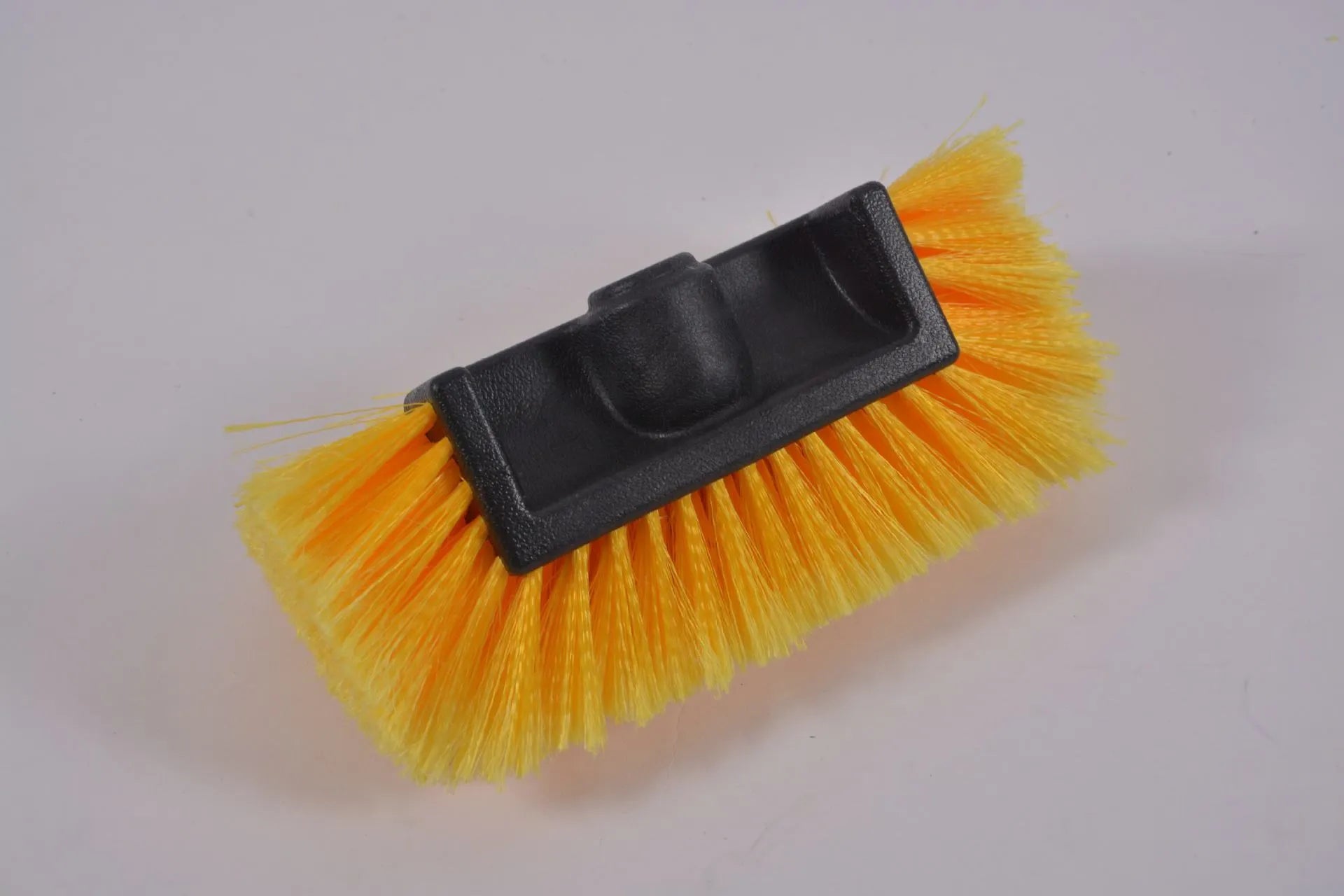 Portable yellow car wash brush with four-section extendable rod and flow-through brush head.
