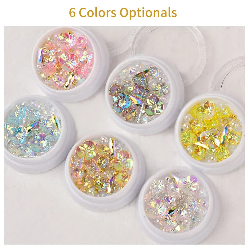 Container of flower and butterfly shaped nail sequins in mixed colours blue champagne grey pink transparent yellow