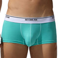 Men's cotton low waist boxer shorts in solid colours: black, blue grey, cyan, and white.