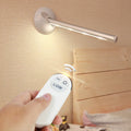 LED mirror lamp with remote control showing dimmable white illumination around vanity mirror