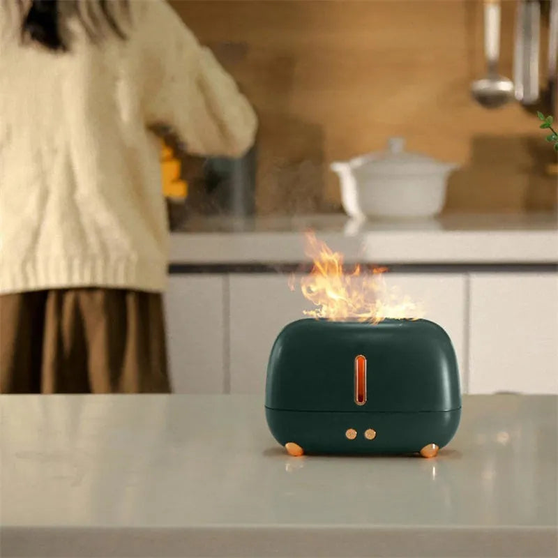 Dark grey flame humidifier with realistic orange LED light and mist output on a wooden table