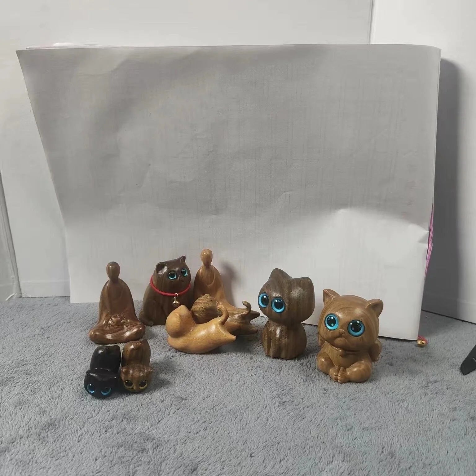 Handcrafted sandalwood kitten ornaments in various styles and colours