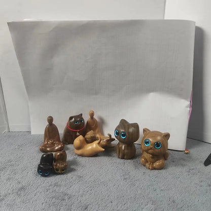 Handcrafted sandalwood kitten ornaments in various styles and colours