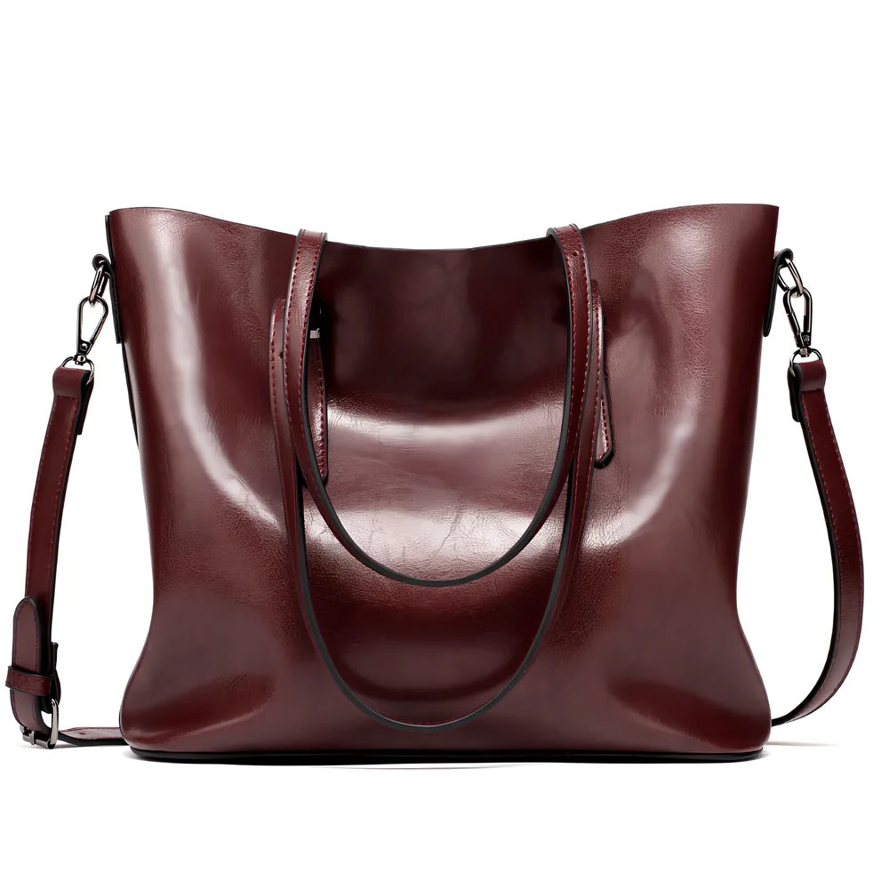 Black oil leather tote bag with square shape, zipper top, soft handle, and internal pockets for winter use