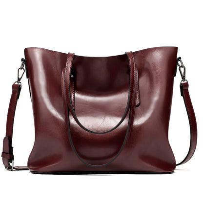 Black oil leather tote bag with square shape, zipper top, soft handle, and internal pockets for winter use