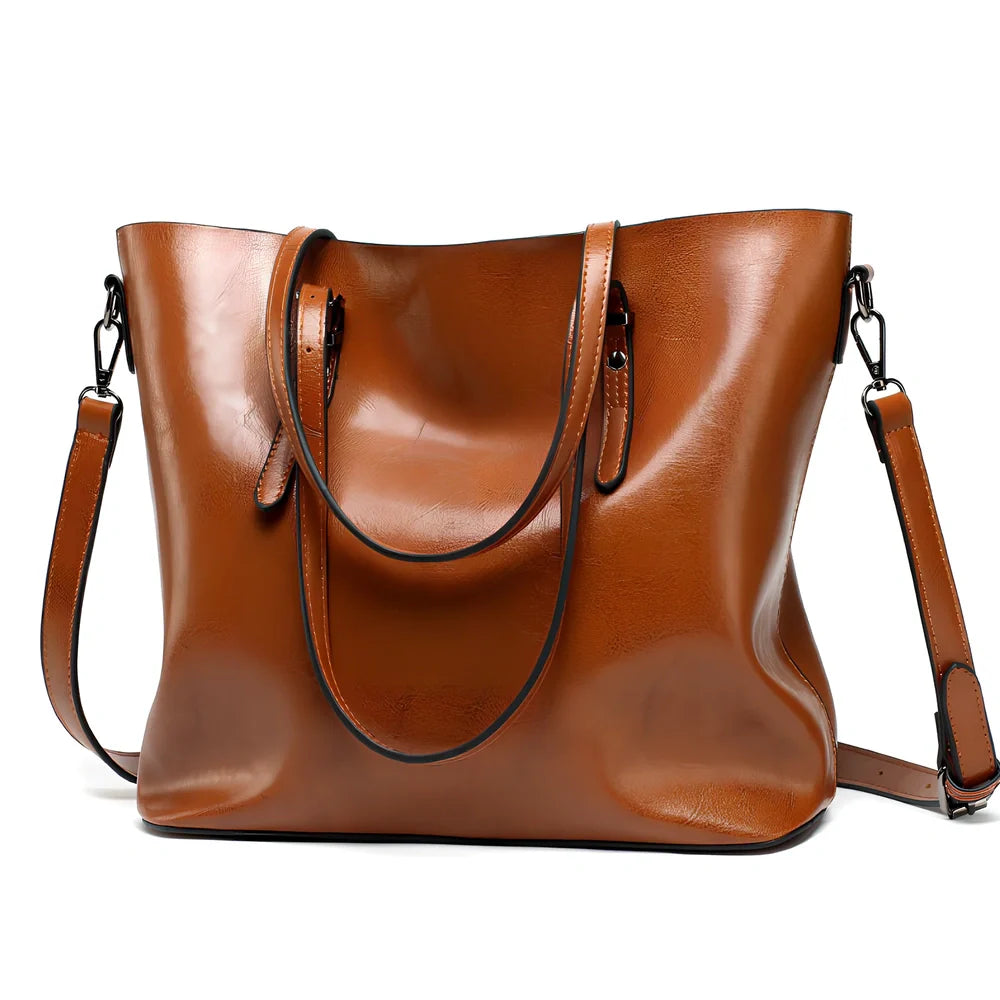 Black oil leather tote bag with square shape, zipper top, soft handle, and internal pockets for winter use