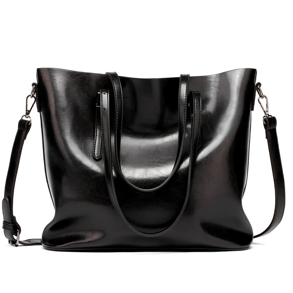 Black oil leather tote bag with square shape, zipper top, soft handle, and internal pockets for winter use