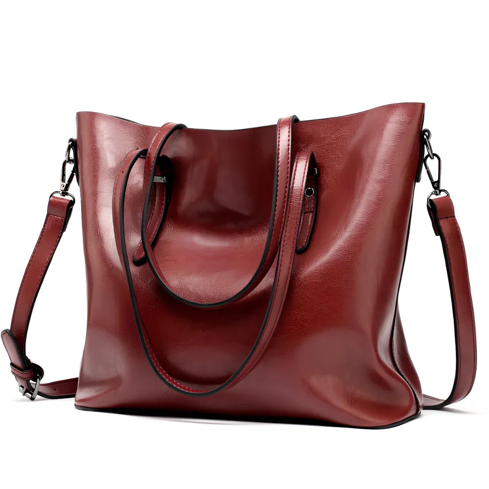 Black oil leather tote bag with square shape, zipper top, soft handle, and internal pockets for winter use