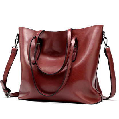 Black oil leather tote bag with square shape, zipper top, soft handle, and internal pockets for winter use