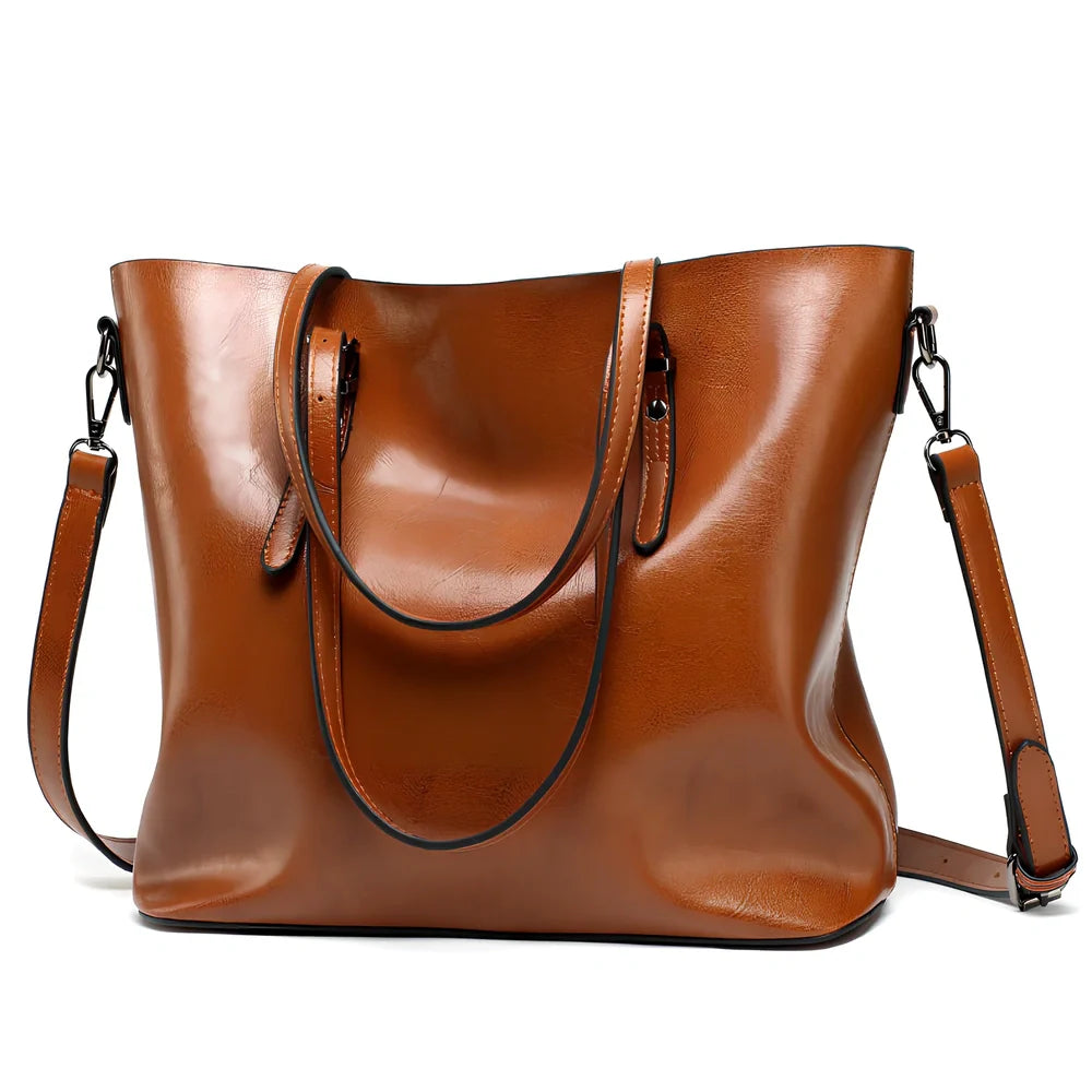 Black oil leather tote bag with square shape, zipper top, soft handle, and internal pockets for winter use