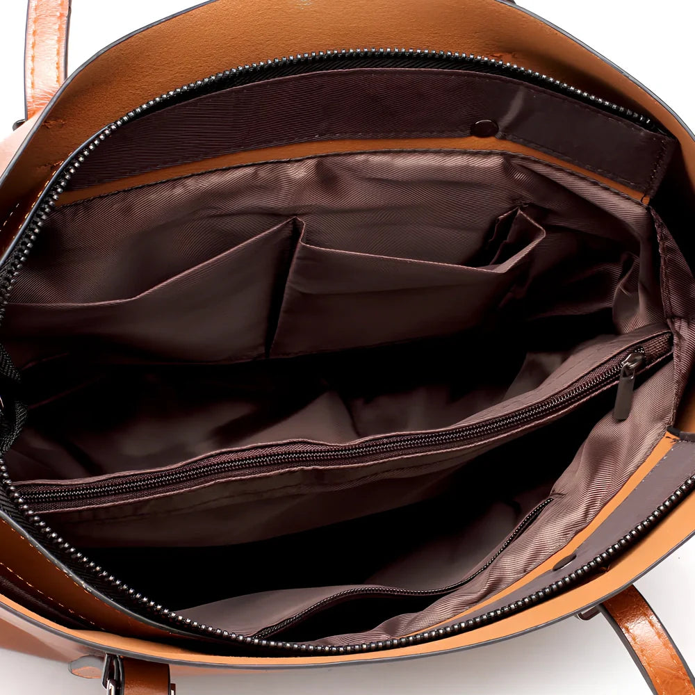 Black oil leather tote bag with square shape, zipper top, soft handle, and internal pockets for winter use