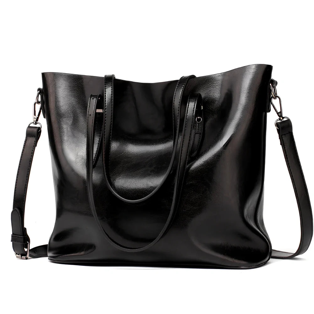 Black oil leather tote bag with square shape, zipper top, soft handle, and internal pockets for winter use