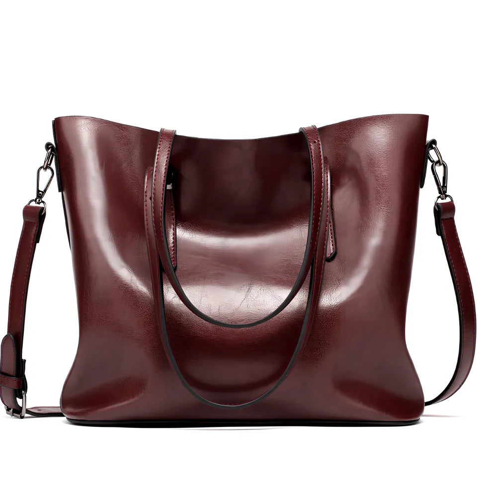 Black oil leather tote bag with square shape, zipper top, soft handle, and internal pockets for winter use