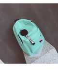 College style canvas rucksack in green with leaf pattern, showing anti-theft features and shoulder straps