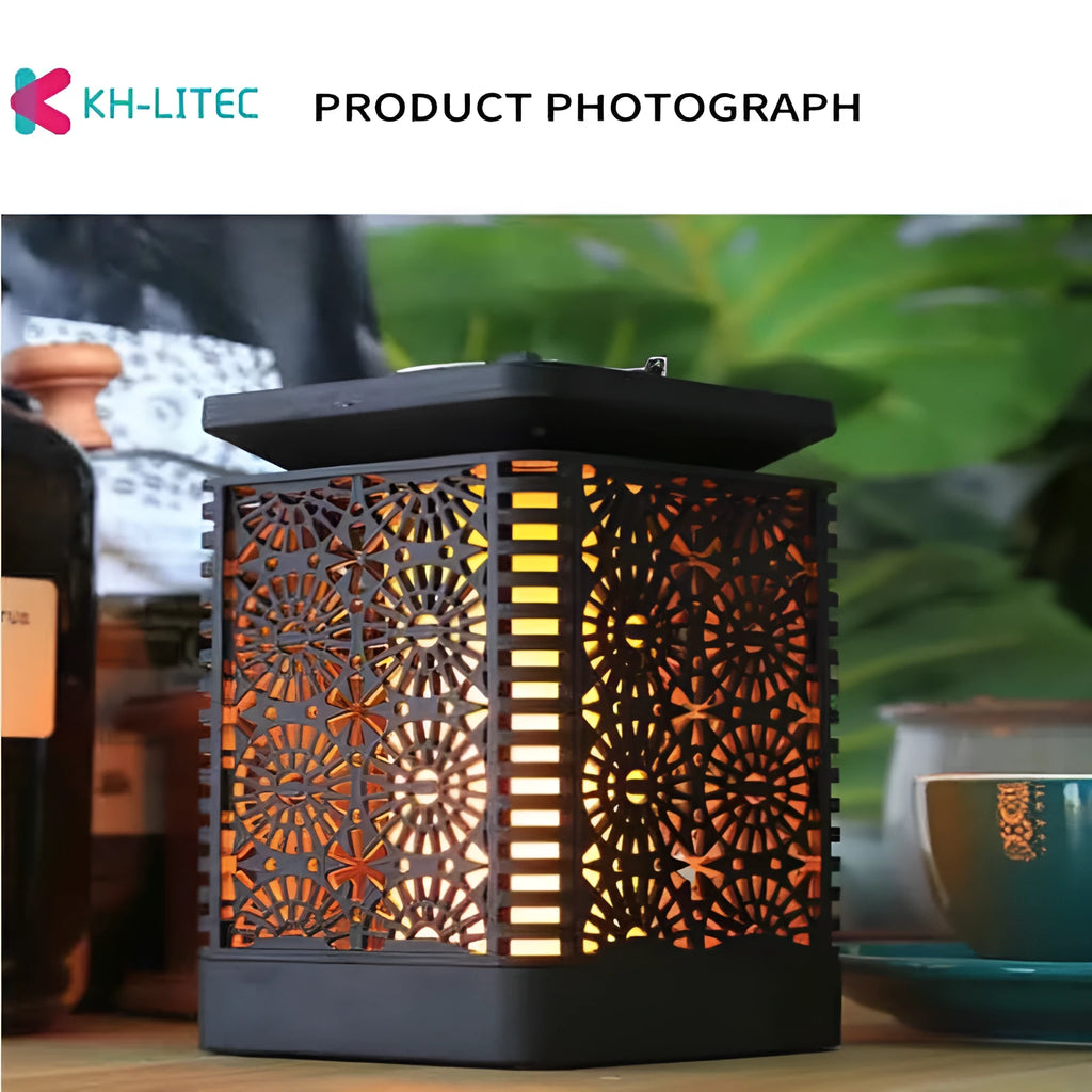 Four black solar-powered hanging lanterns with flickering flame LED light effect for outdoor garden decoration.