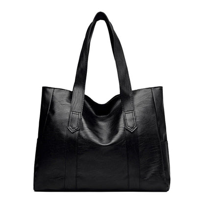 Large capacity commuter tote bag in brown and black with double shoulder straps and mobile phone pocket
