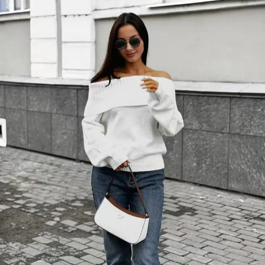 Grey off-the-shoulder acrylic sweater with a textured 3D pattern on a hanger.