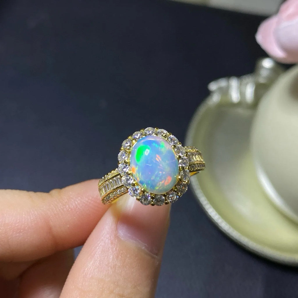 Handmade adjustable opal ring on a sterling silver open band with gold tone plating.