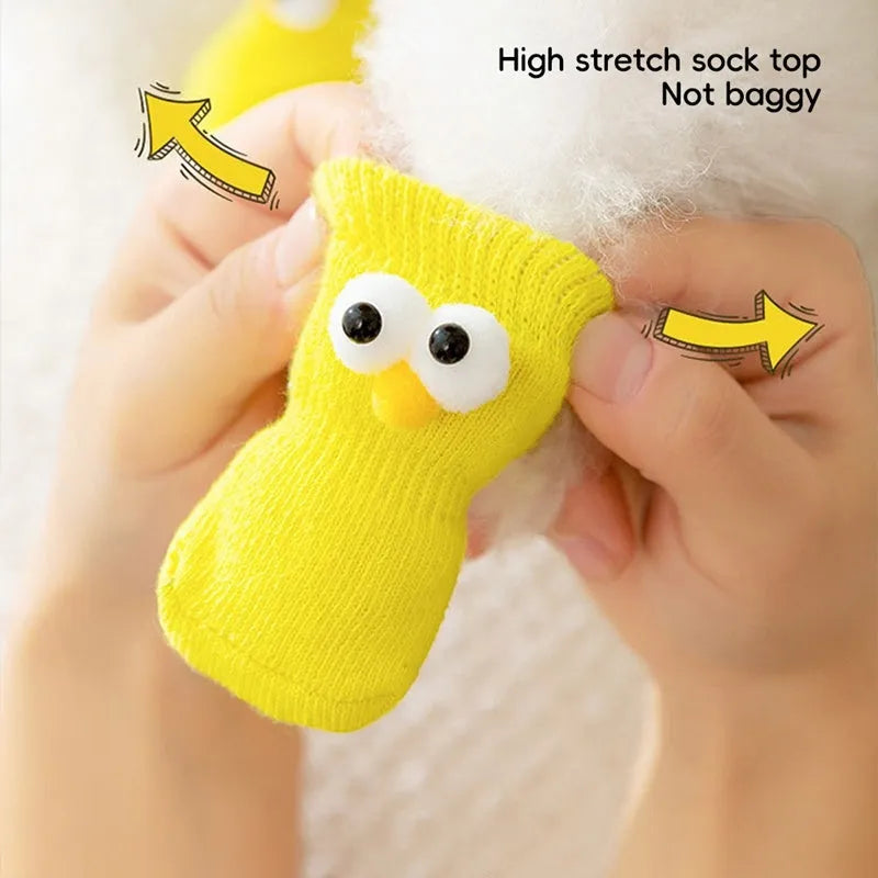 Dog all-season universal cotton socks with cute big eyes, anti-slip sole, green colour, side view on wooden floor
