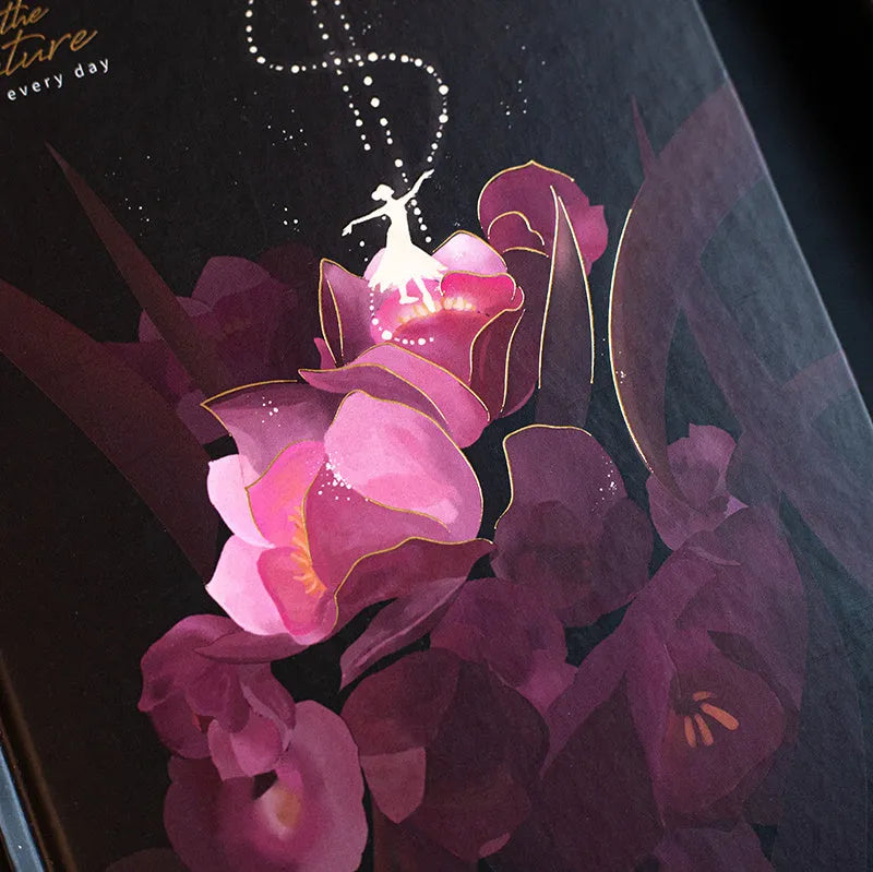 A5 notebook with luminous cover open to show colour illustration inside, in deep blue colour option.
