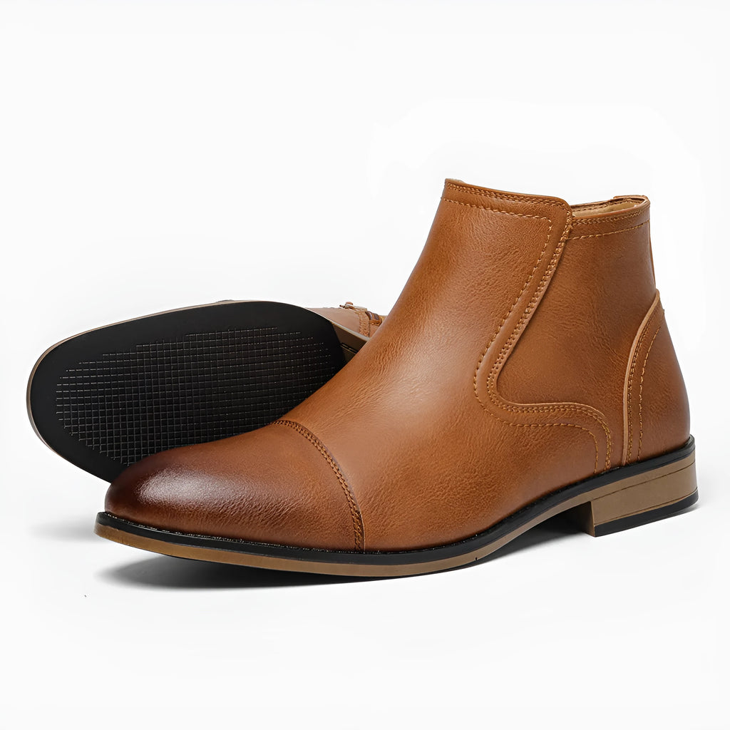 Men's brown Chelsea ankle boots with a side zip, shown on a foot.