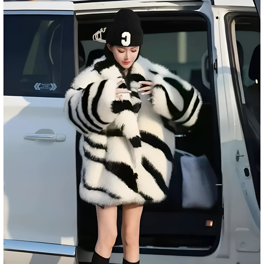 Zebra stripe patterned women's faux fur top with long sleeves and a skimmer collar.